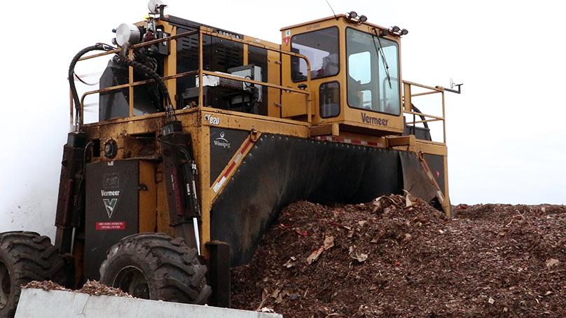 A large machine is used to turn the compost.