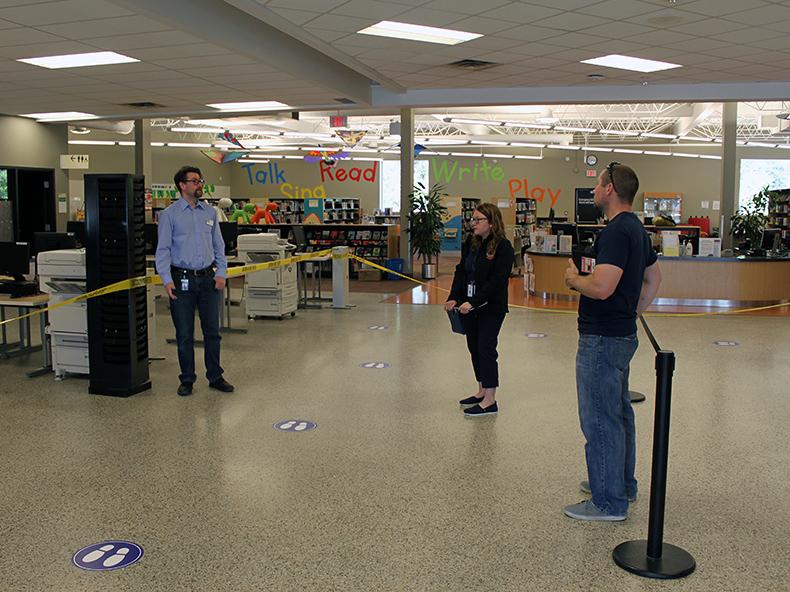 Office of Emergency Management employees receive a tour of the new procedures at Henderson Library from Branch Head Andrew McCulloch.