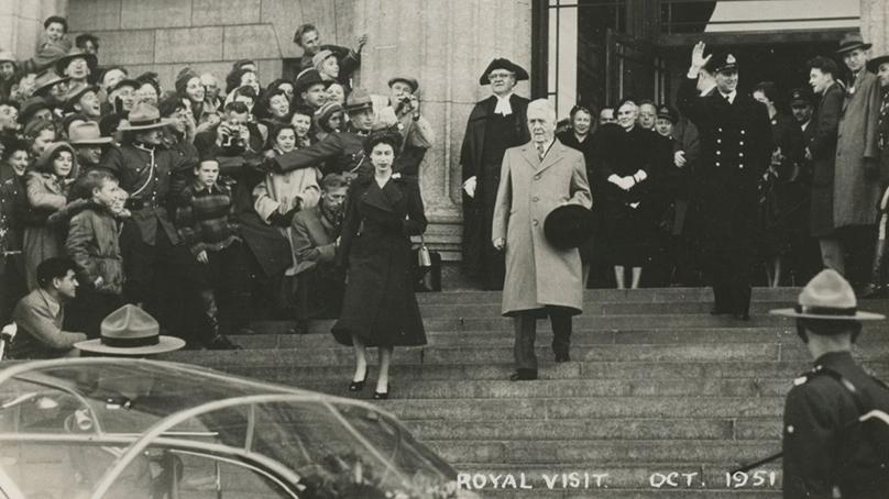 Royal Tour, Winnipeg, October 16, 1951. Princess Elizabeth, Duchess of Edinburgh (later Queen Elizabeth II, left) and the Duke of Edinburgh (or Prince Philip) descend the stairs of the Manitoba Legislature. City of Winnipeg Archives.