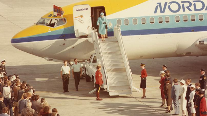 Queen Elizabeth II disembarking from airplane.