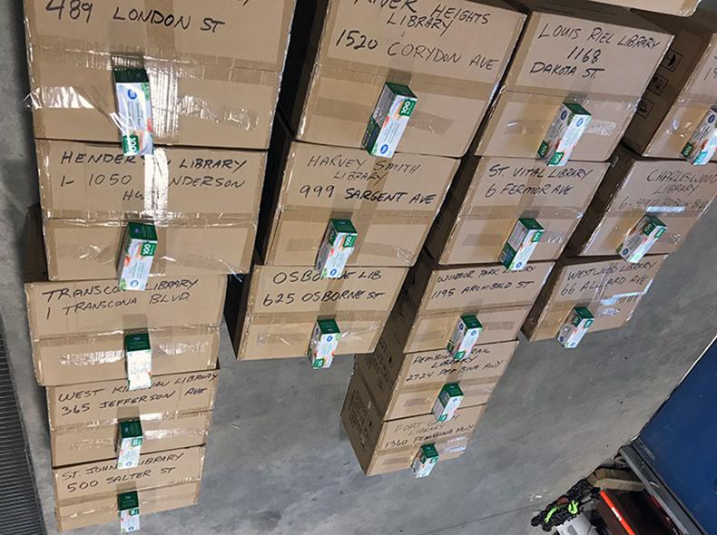 Boxes of disposable masks are prepared to be distributed to Winnipeg Public Library branches.