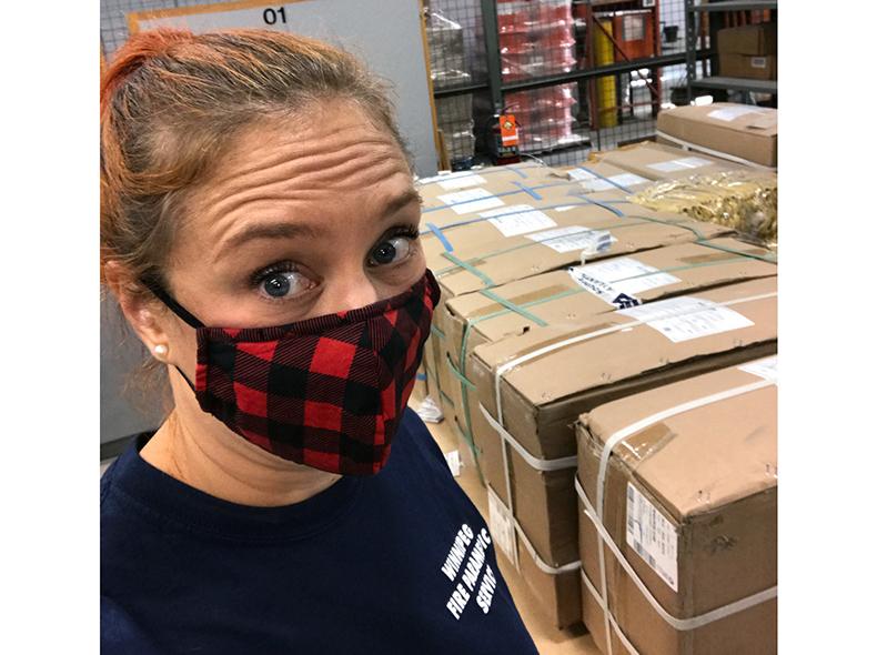Nicole Czajka, an Emergency Management Officer with our Office of Emergency Management, organizes the boxes of disposable masks for distribution.