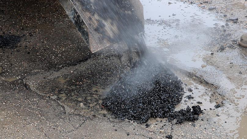 Crews make temporary patches using cold mix, an asphalt mix specifically designed for use in cold, wet weather.