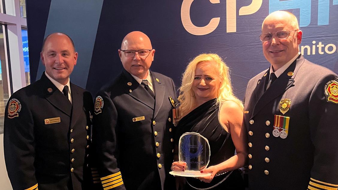 The Winnipeg Fire Paramedic Service with their HR Excellence Award, including Christian Schmidt (left), WFPS Fire and Paramedic Chief, and Corinne Pierce (centre right), WFPS’ Human Resource Manager.
