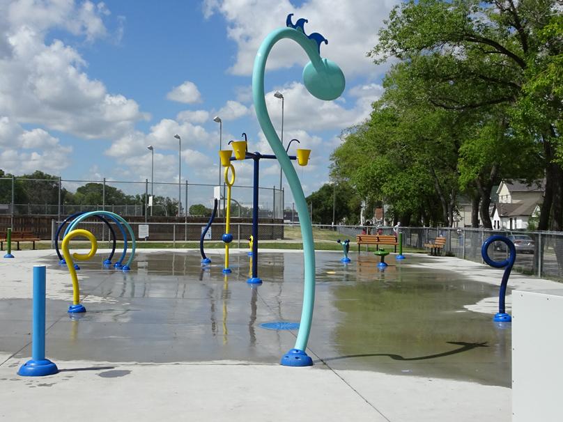 Blue sprinkler in use at Freight House Spray Pad