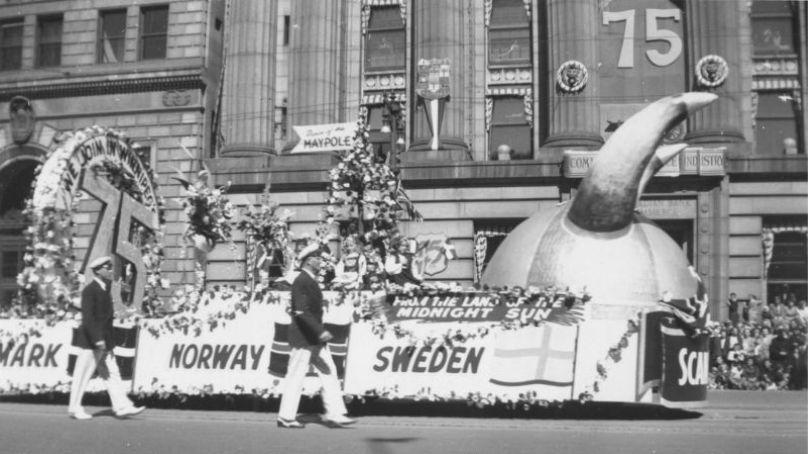 Scandinavian-themed float in front of the Canadian Bank of Commerce on Main Street during Winnipeg's 75th Anniversary Parade