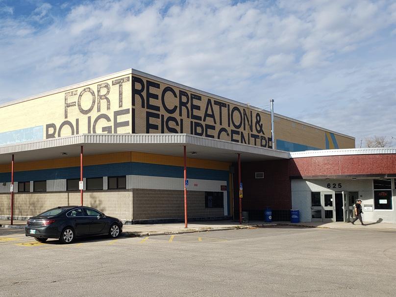 Cars sit in the parking lot on a late fall day in front of the Fort Rouge Leisure Centre.