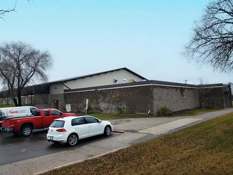 White and red vehicles sit in the parking lot in front of Charlie Gardiner Arena.
