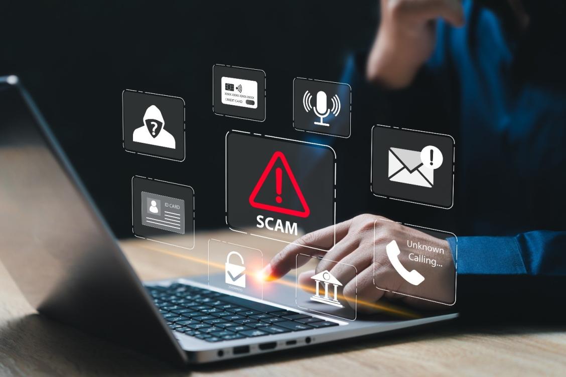 Person at computer being warned of a scam