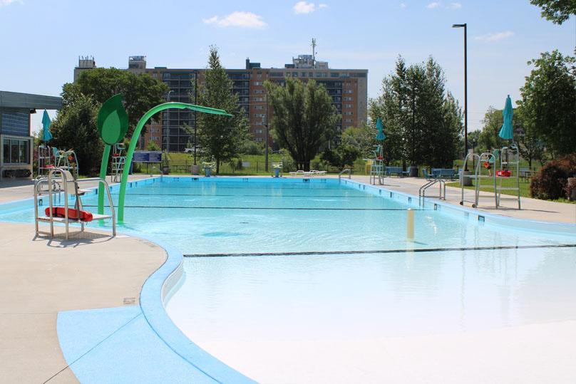 Spray features arch over top of the shallow end of the St. Vital Pool.