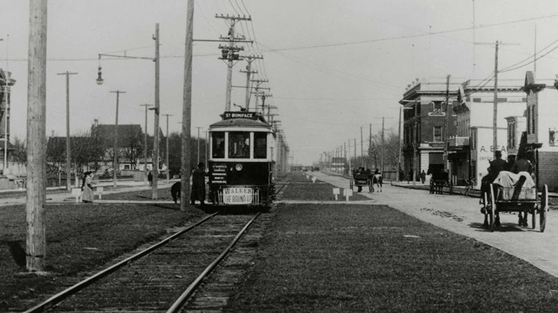 The westbound St. Boniface streetcar No. 184 loading passengers at St. Boniface City Hall on the single rail track in the centre of Provencher Ave. Taken in 1910.
From the Herbert William Blake Collection