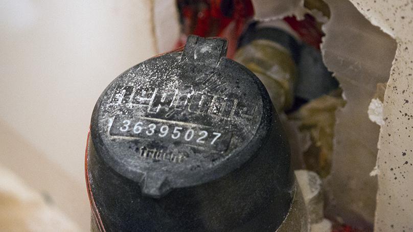 A water meter with the lid closed, showing the meter number.