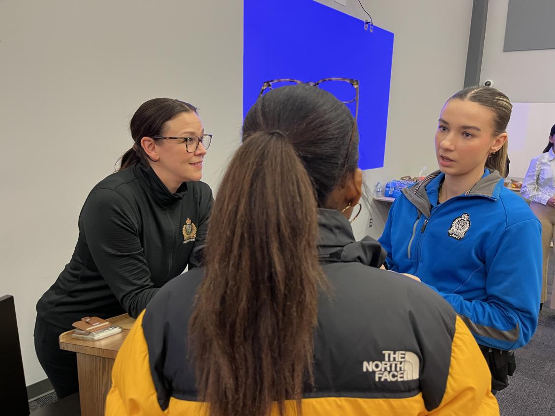 Participant speaking with officer and cadet
