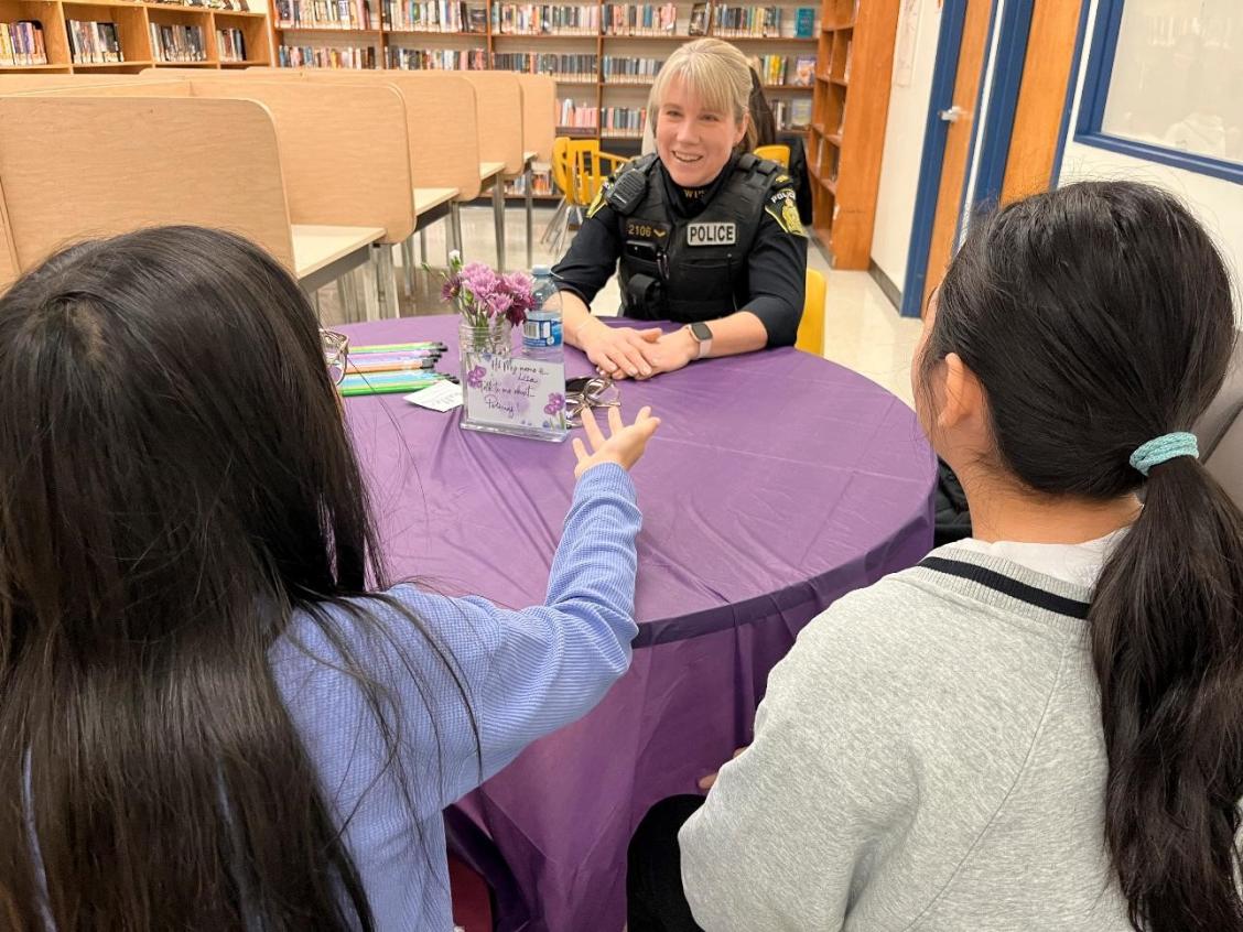 Cst. Lisa Allison speaks with students at the Human Library