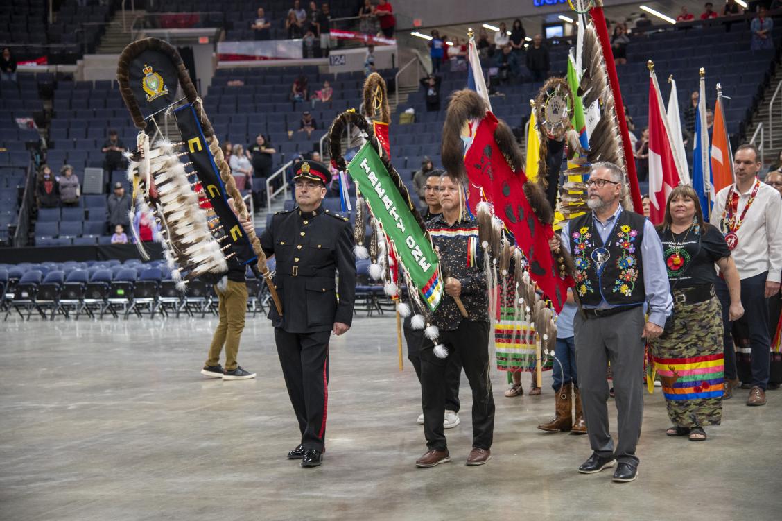 Inspector Kevin Riel and Assistant Superintendent Rob Riel carry Eagle Staffs during the Grand Entry at the Winnipeg School Division Graduation Pow Wow.