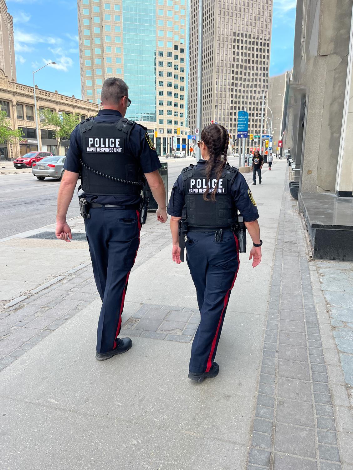 two officers walking down Portage avenue toward Main Street
