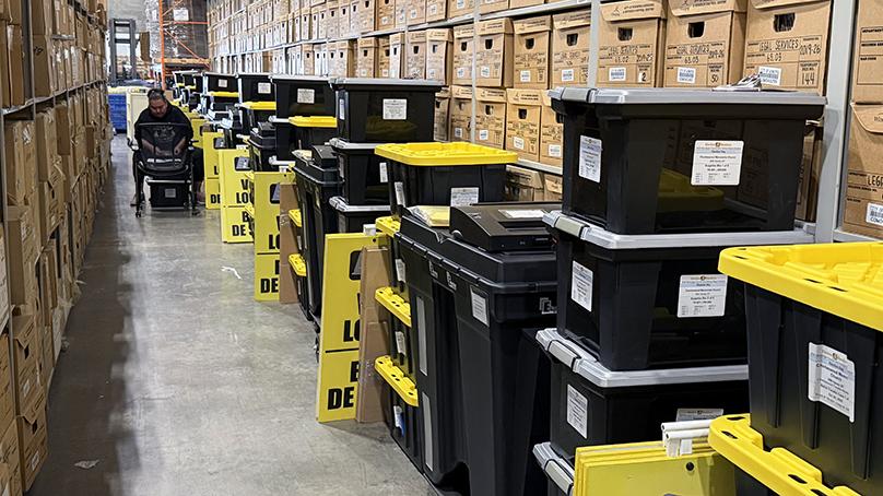 City staff work quickly and carefully to load voting location supplies into delivery trucks ahead of Election Day.